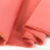 JK - Marmaris - Coral -Croft Mill Store jk mamaris coral cotton stretch twilled trousering dress fabric close up drape fabric photo